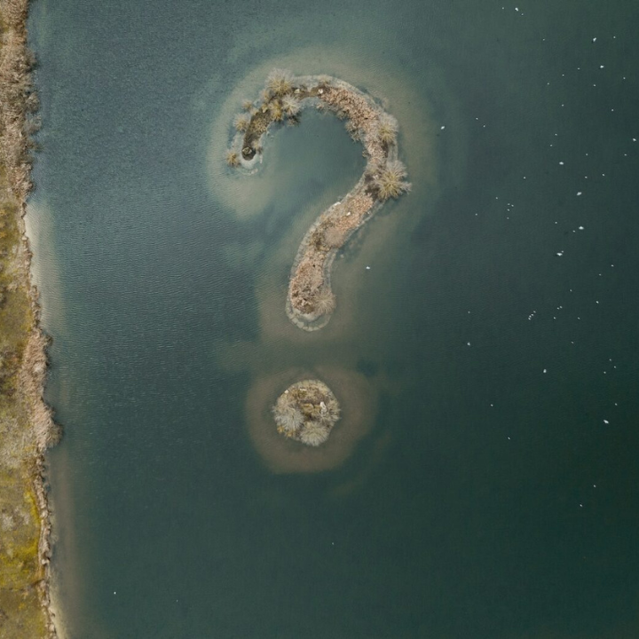 question mark islands in murky water